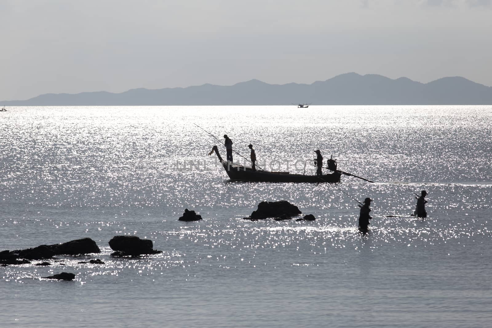 Krabi Thailand 12.16.2015 looking out to sea with fishermen silhouetted silver by kgboxford