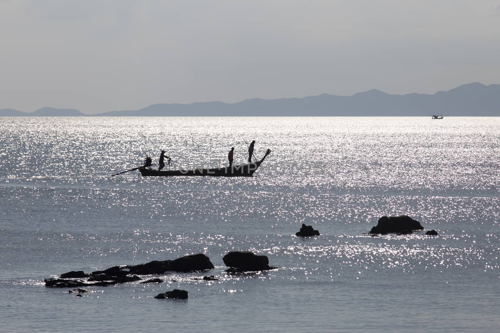 Krabi Thailand 12.16.2015 looking out to sea with fishermen silhouetted silver by kgboxford