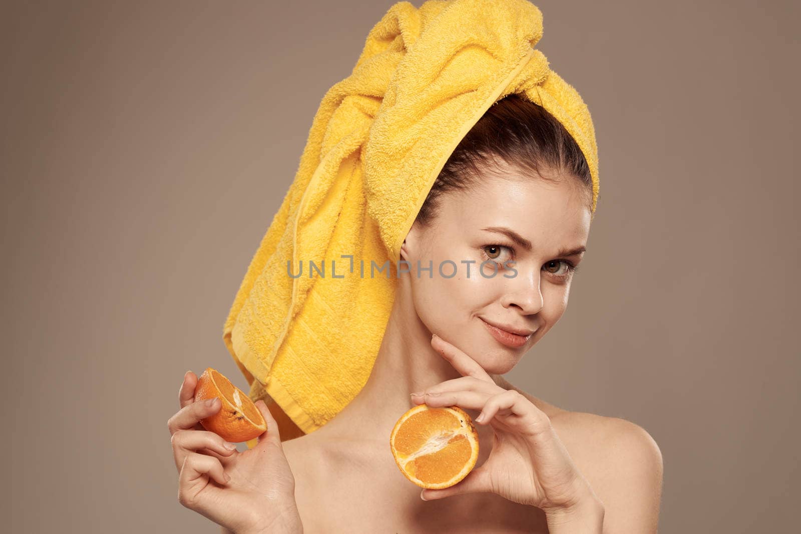 woman with a towel on her head bared shoulders citrus fruits in hands skin care by SHOTPRIME