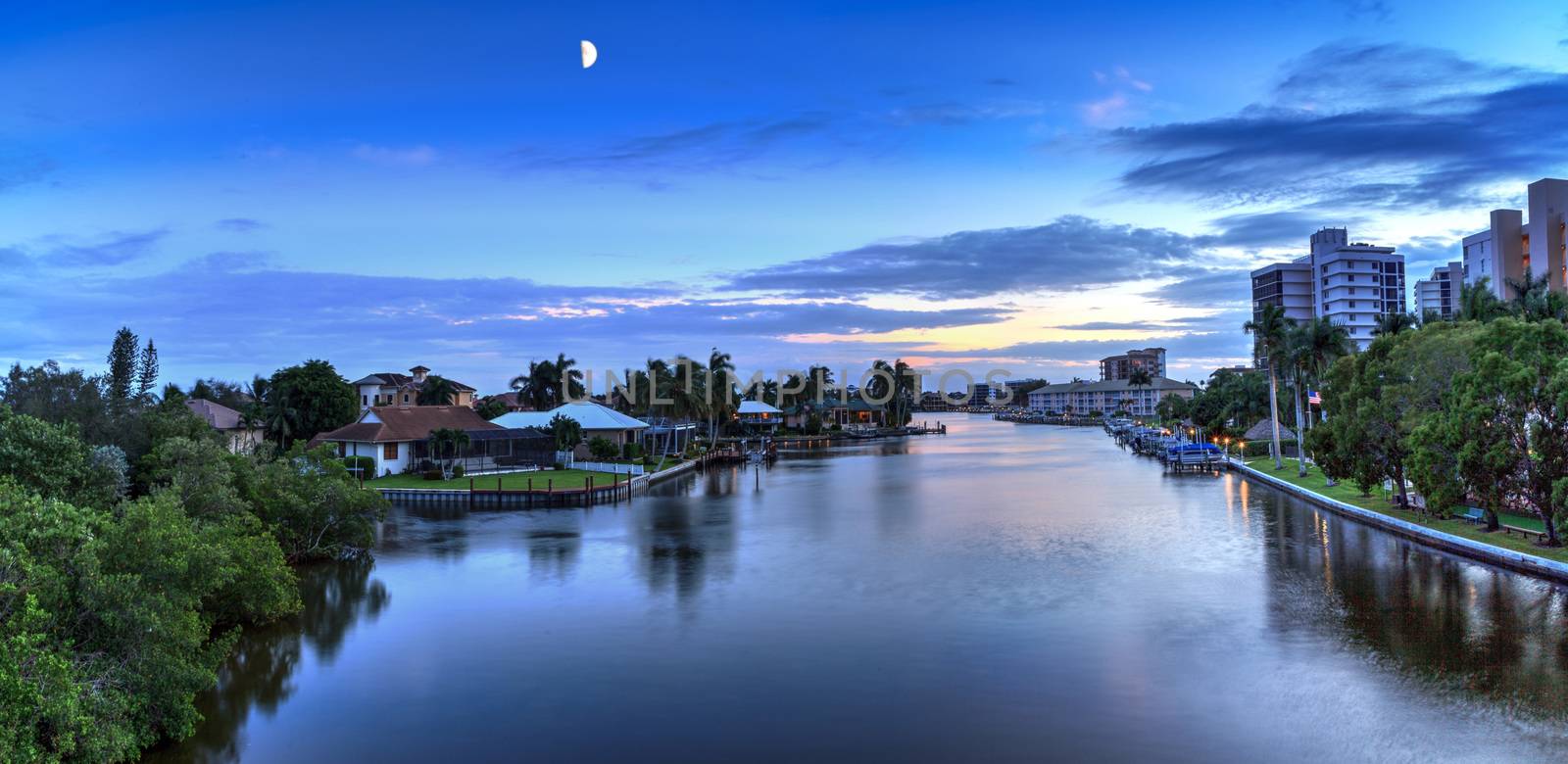 Moon comes up over Wiggins Pass in Naples, Florida.