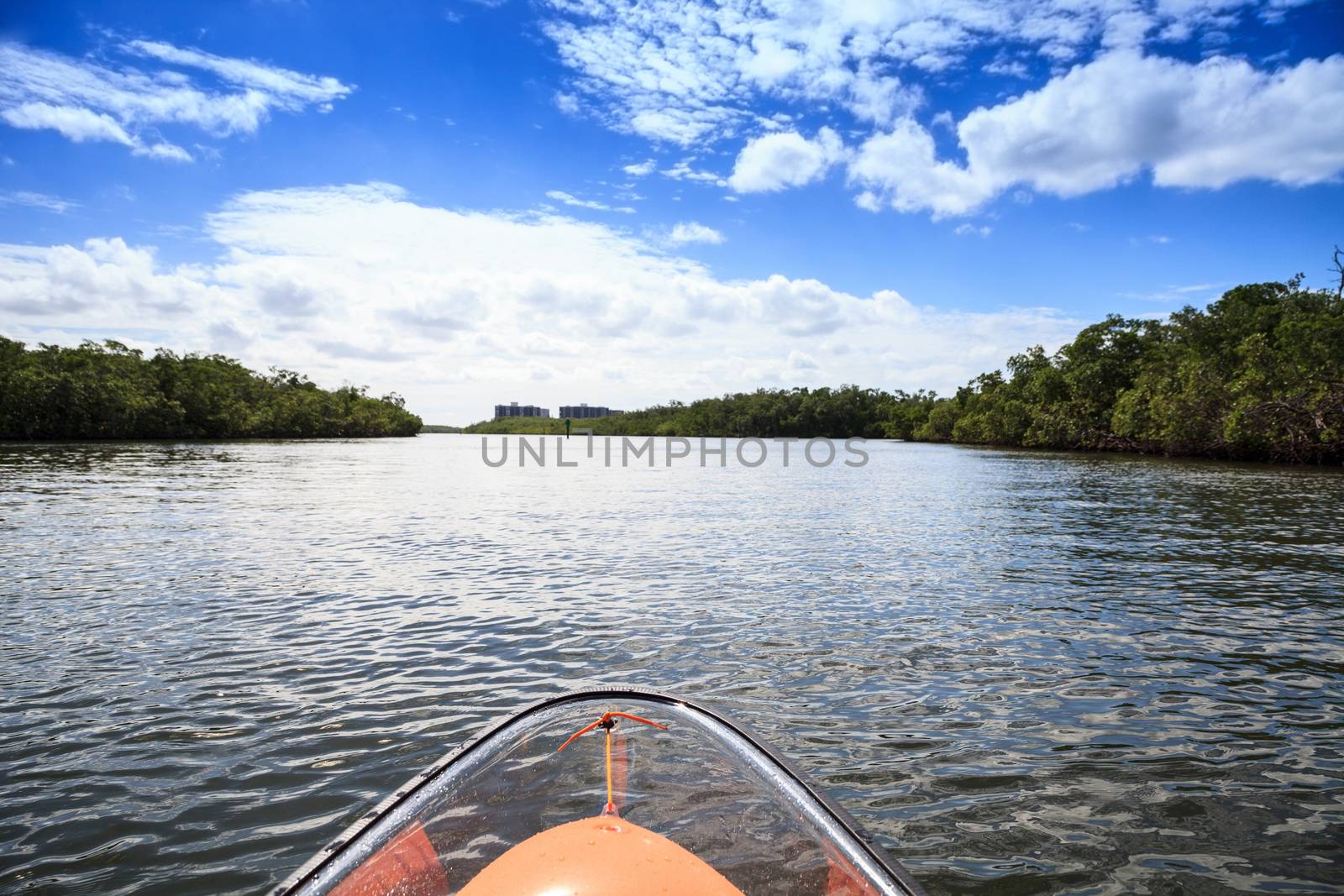 Clear see-through kayak forges its way through the waters of Delnor-Wiggins pass in Bonita Springs, Florida.