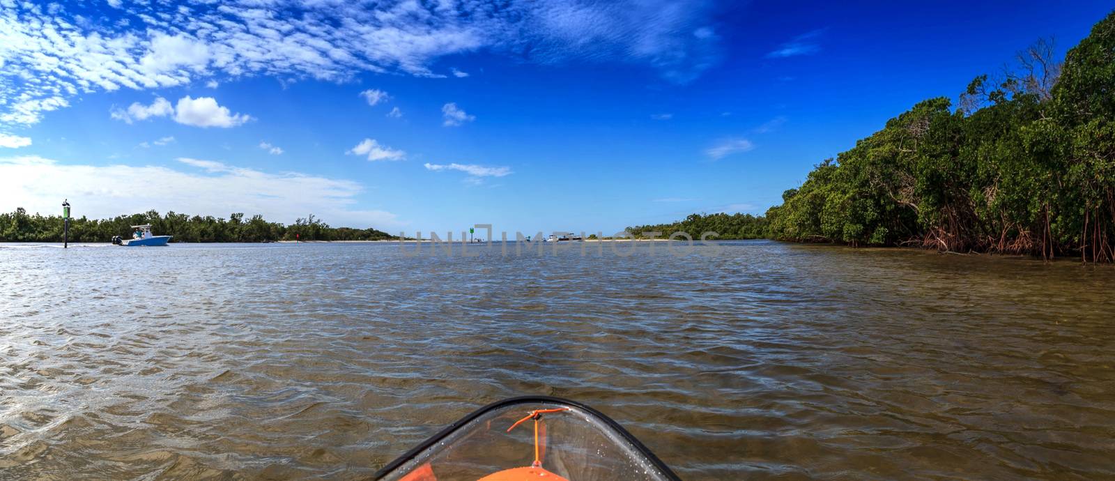 Clear see-through kayak forges its way through the waters of Delnor-Wiggins pass in Bonita Springs, Florida.