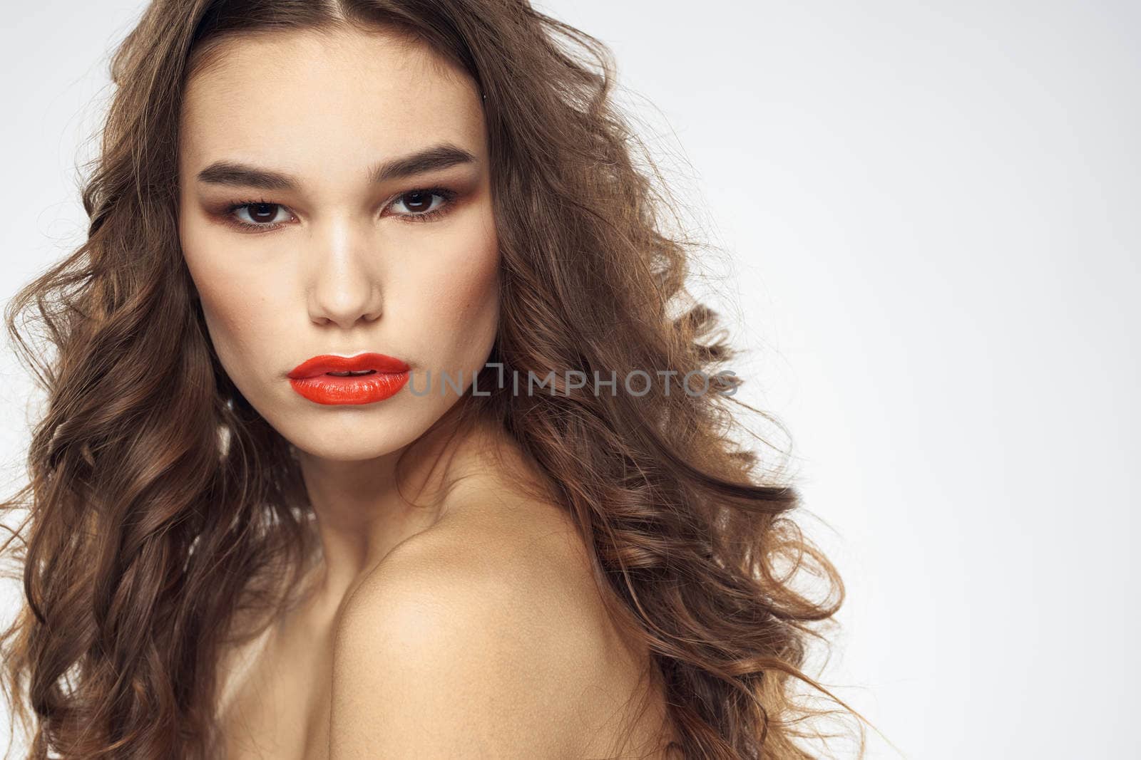 Elegant woman with bare shoulders red lips glamor attractive look cropped look. High quality photo