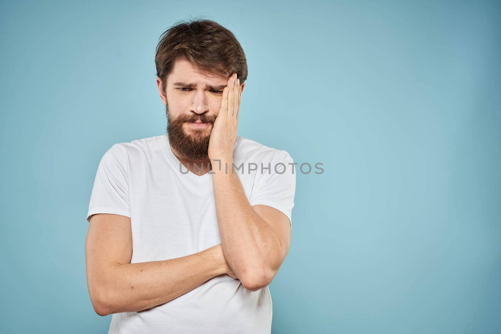 Bearded man emotions white t-shirt lifestyle gestures with hands blue backgrounds. High quality photo