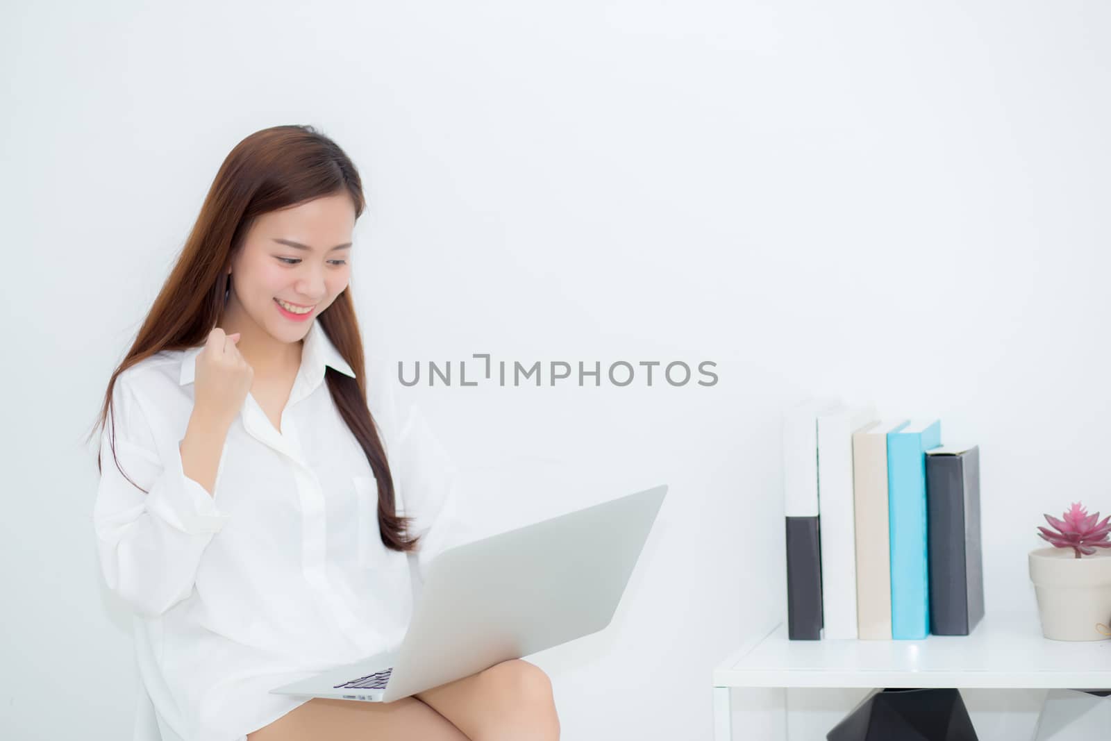 Beautiful of portrait happy young asian woman using laptop work  by nnudoo