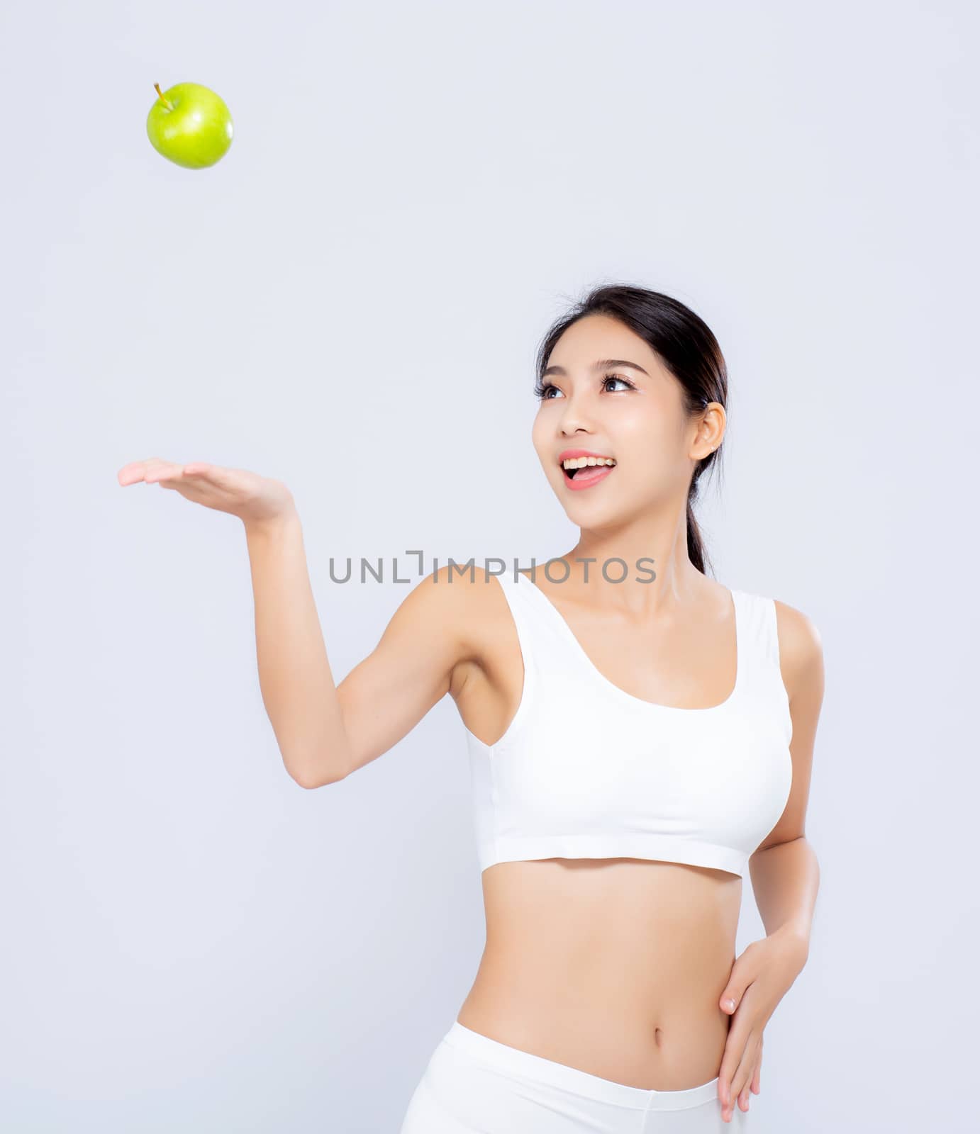 Portrait asian woman smiling throw green apple fruit and beautiful body diet with fit isolated on white background, girl weight slim with cellulite or calories, health and wellness concept.