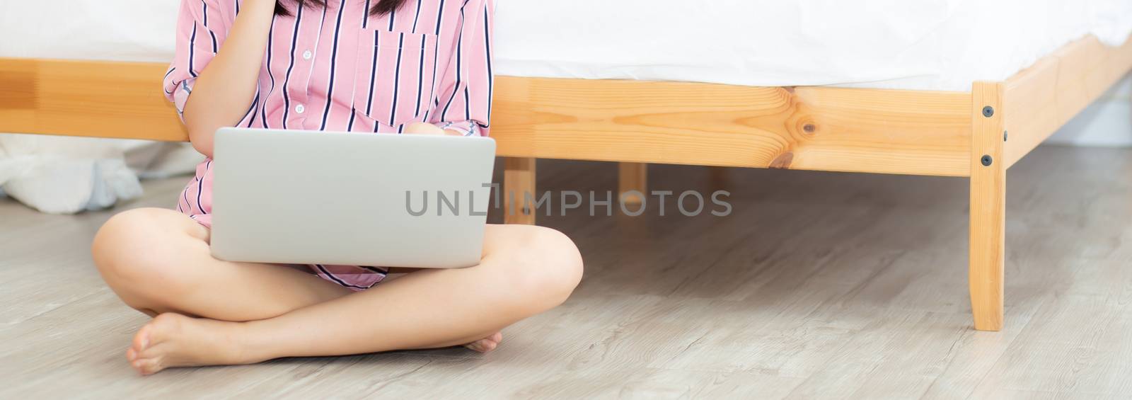 Banner website asian young woman sitting in bedroom using laptop by nnudoo