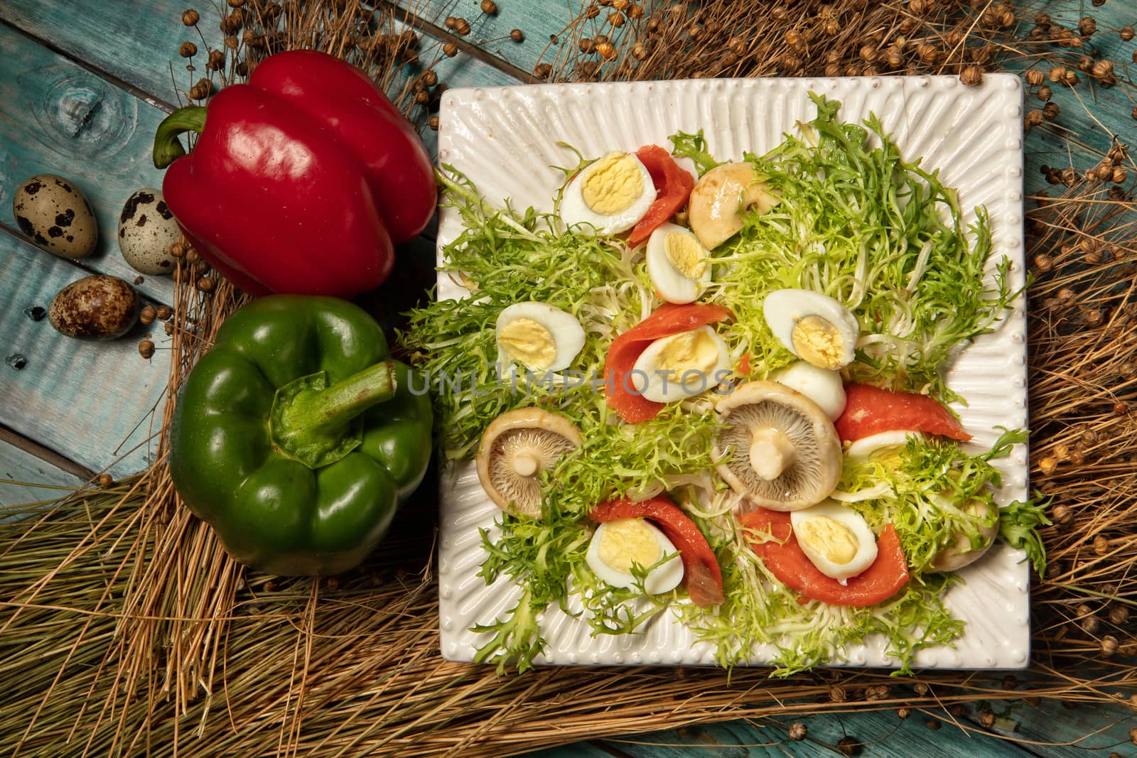 Salad with mushrooms and vegetables on an old wooden desk