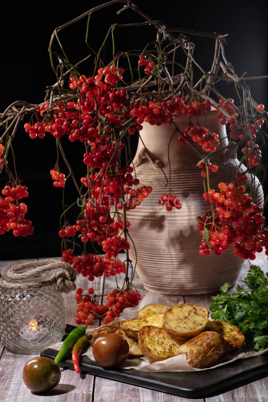 Roasted potatoes and ashberry in ceramic vase