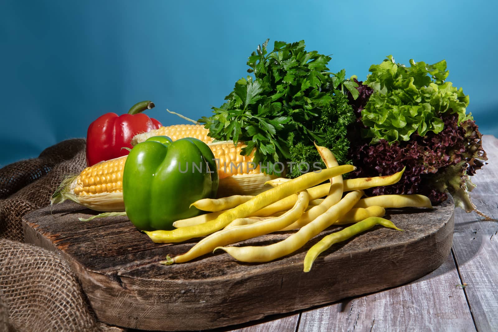 Maize, greenery and pepper on a wooden table