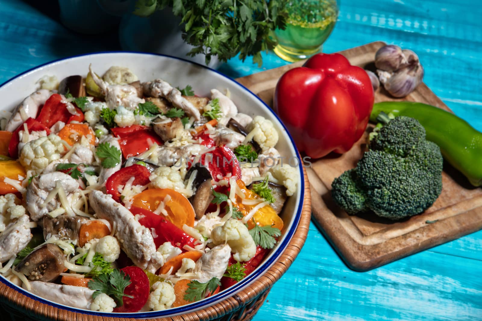 Salad with chicken and vegetables on an old wooden desk