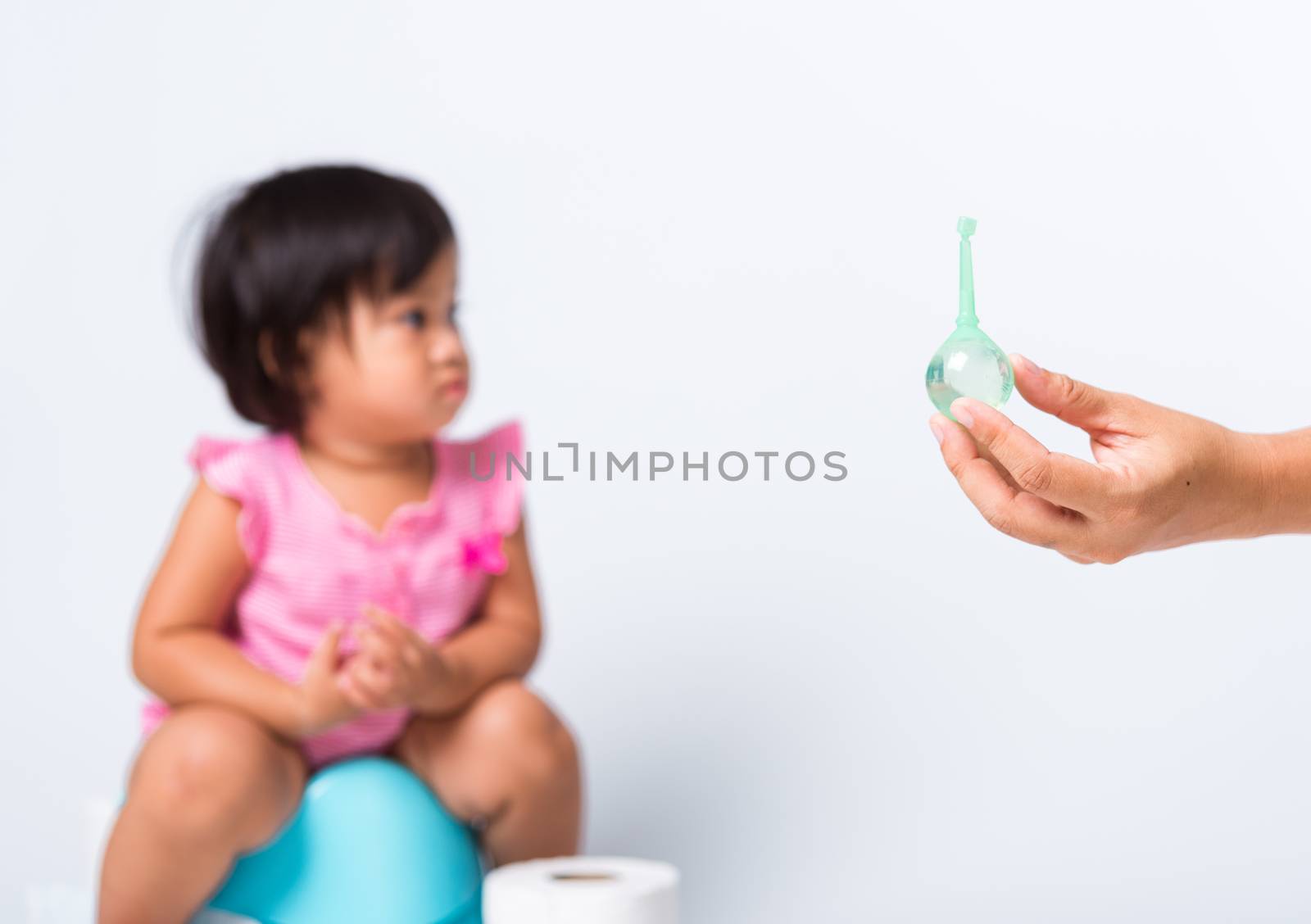 baby child girl training to sitting on blue chamber pot or potty by Sorapop