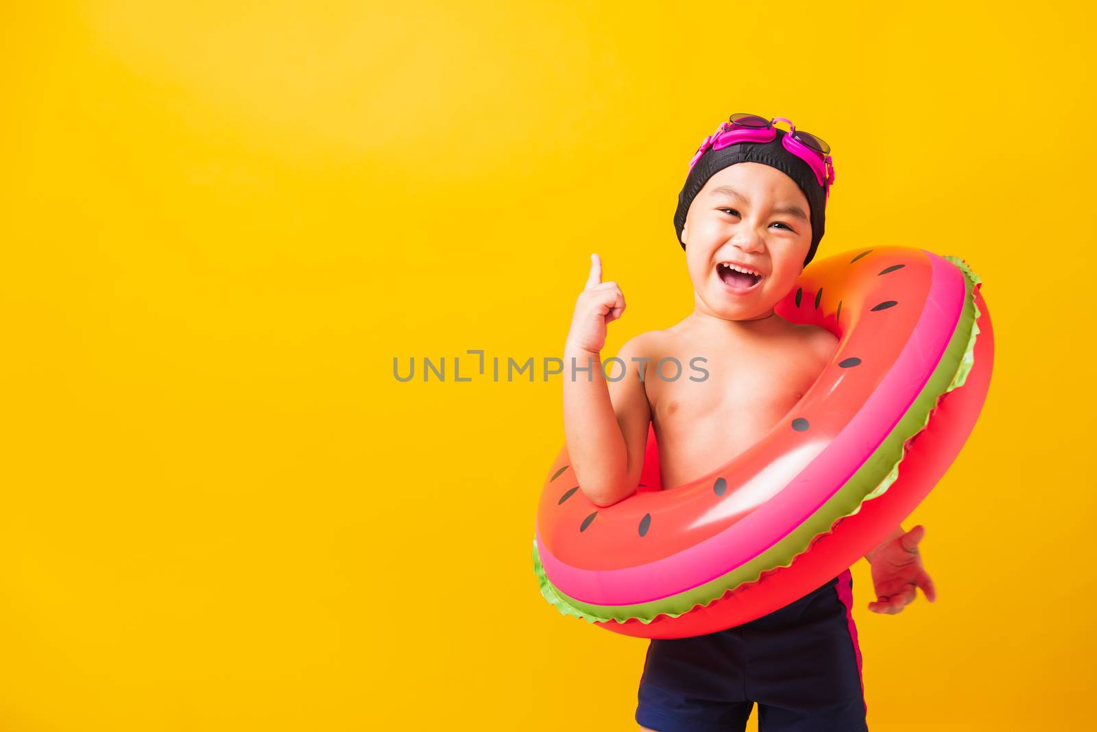 Child boy wearing goggles and swimsuit holding beach watermelon  by Sorapop