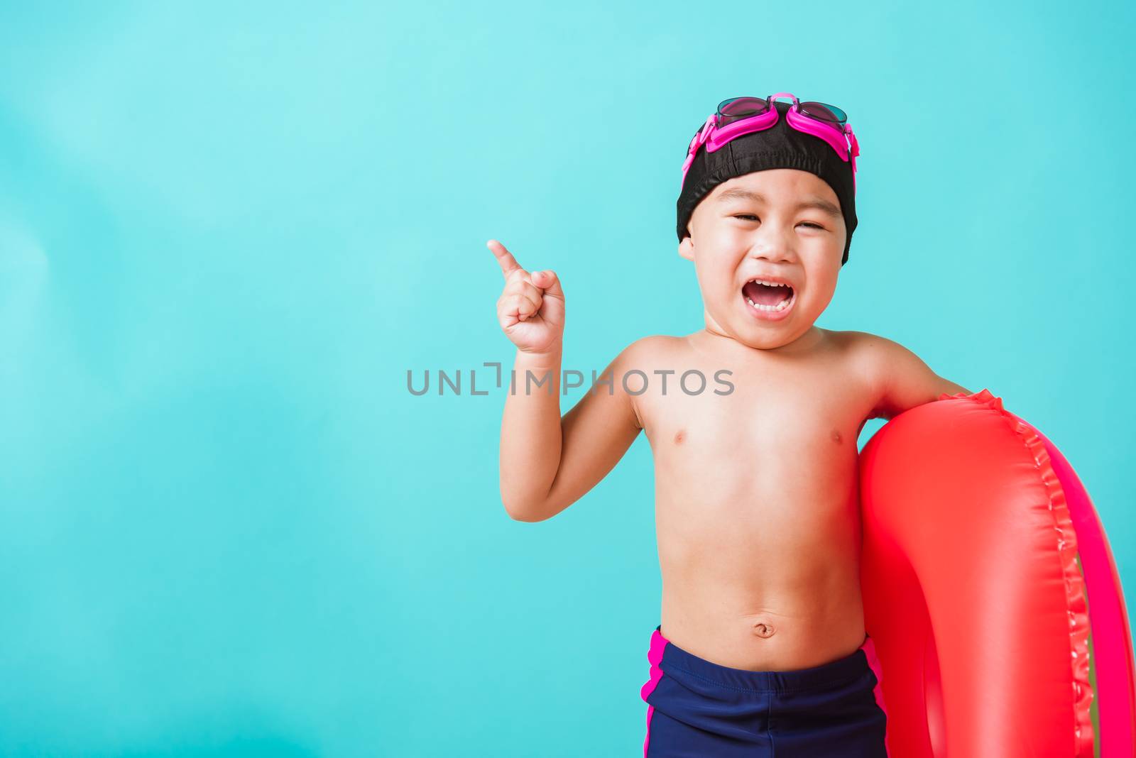 Child boy wearing goggles and swimsuit holding beach watermelon  by Sorapop