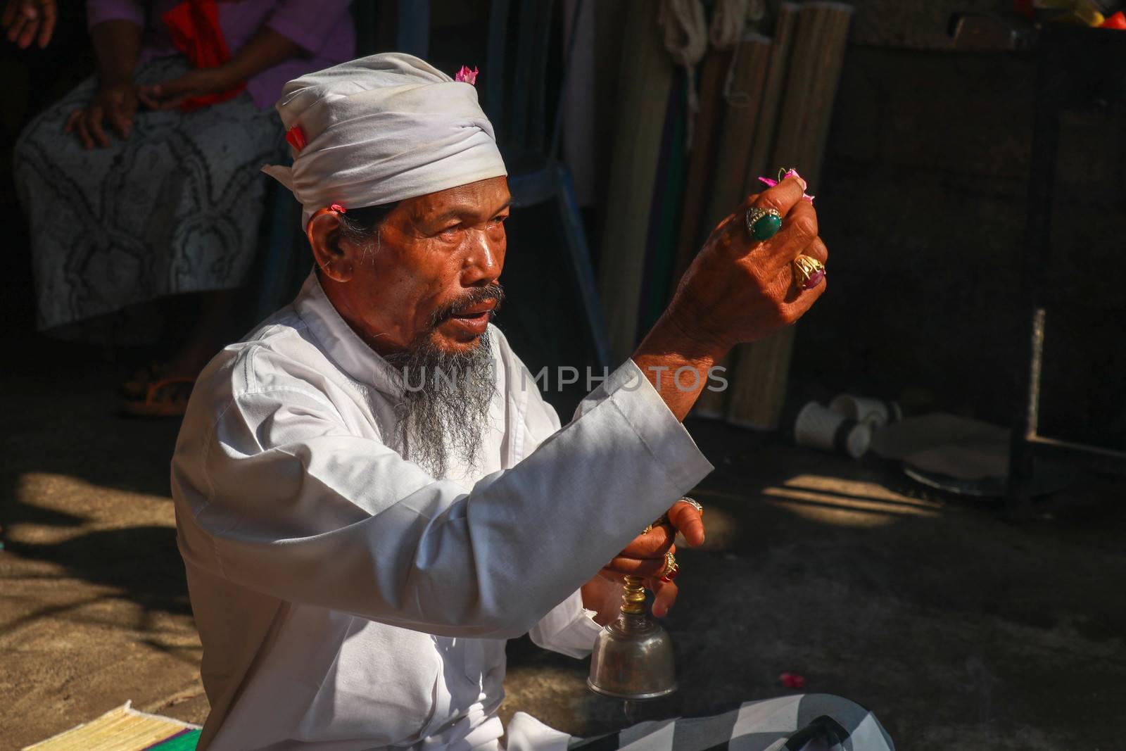 Close up of Hindu priest prays during a wedding ceremony. The pedanda performs wedding ceremonies by Sanatana2008