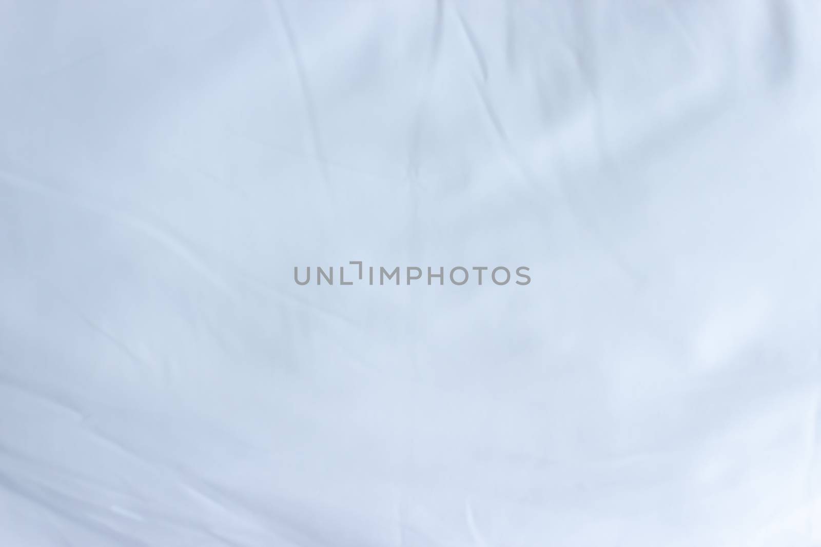 Top view of white fabric bed sheet with pillowcases texture back by kaisorn