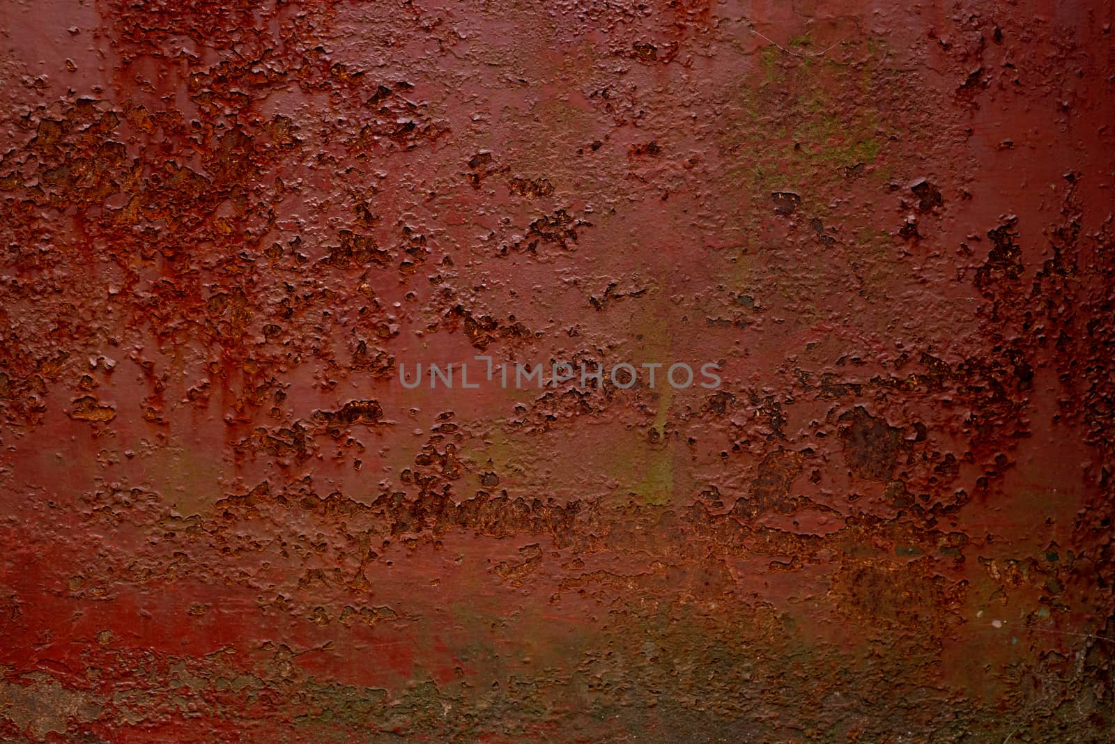 Abstract colorful image painted in red on an outdoor rotten metal