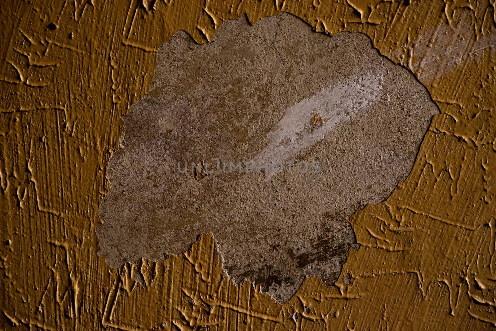 Abstract painted of rotten wall in orange or mustard color in Prague, Czech Republic