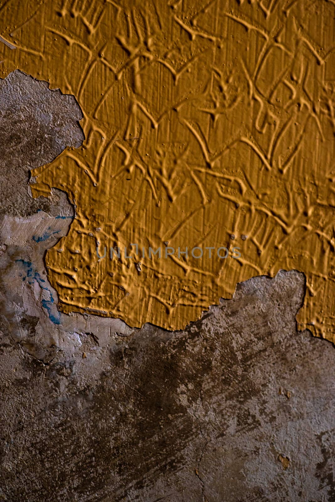 Abstract painted of rotten wall in orange or mustard color by gonzalobell