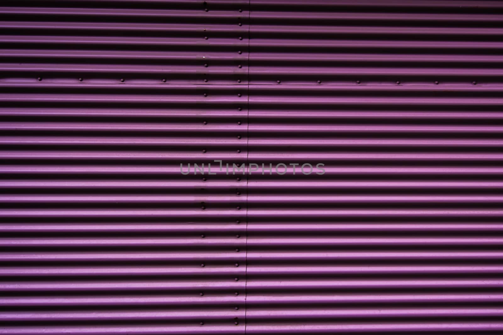 Abstract of a metal entrance in pink or purple colors