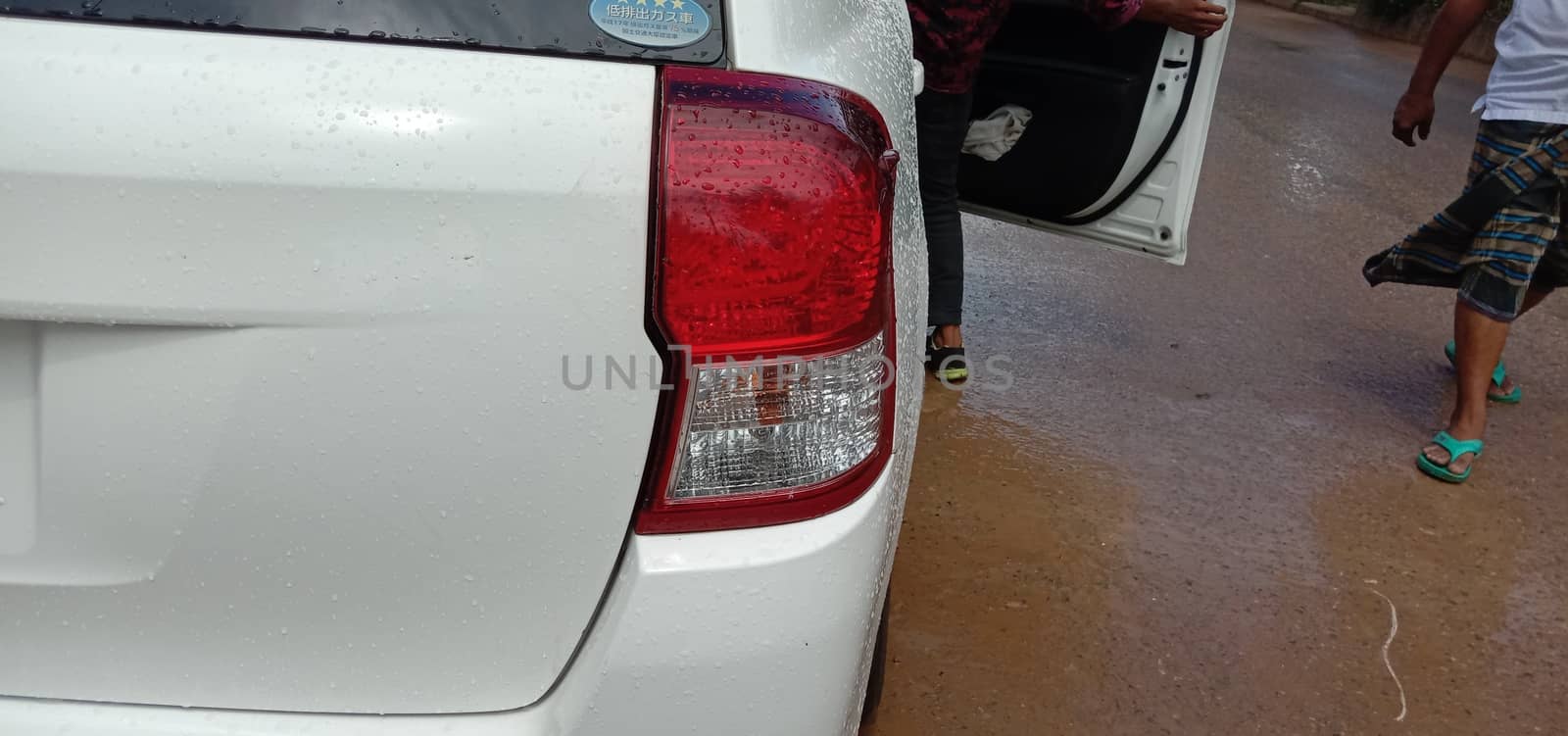 back side of white colored car on road