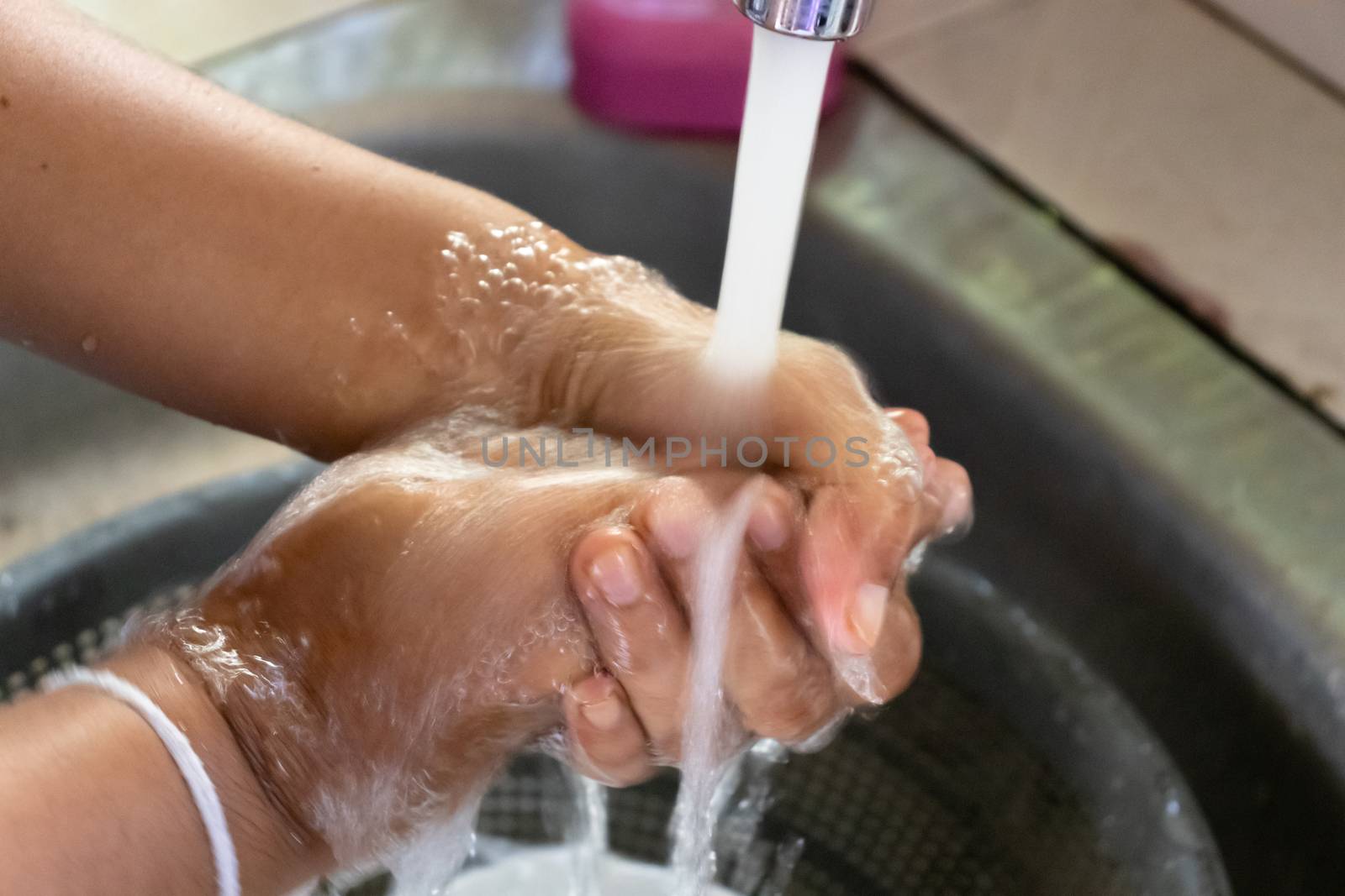 applying soap and washing with clean running water