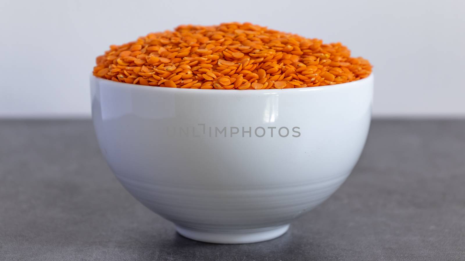 Bowl of Dhal seeds front view Neutral background with negative space to add caption