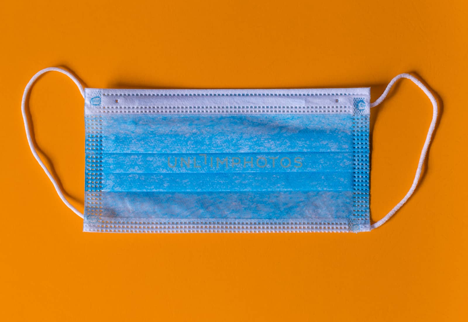 New isolated Medical face mask in a Orange background