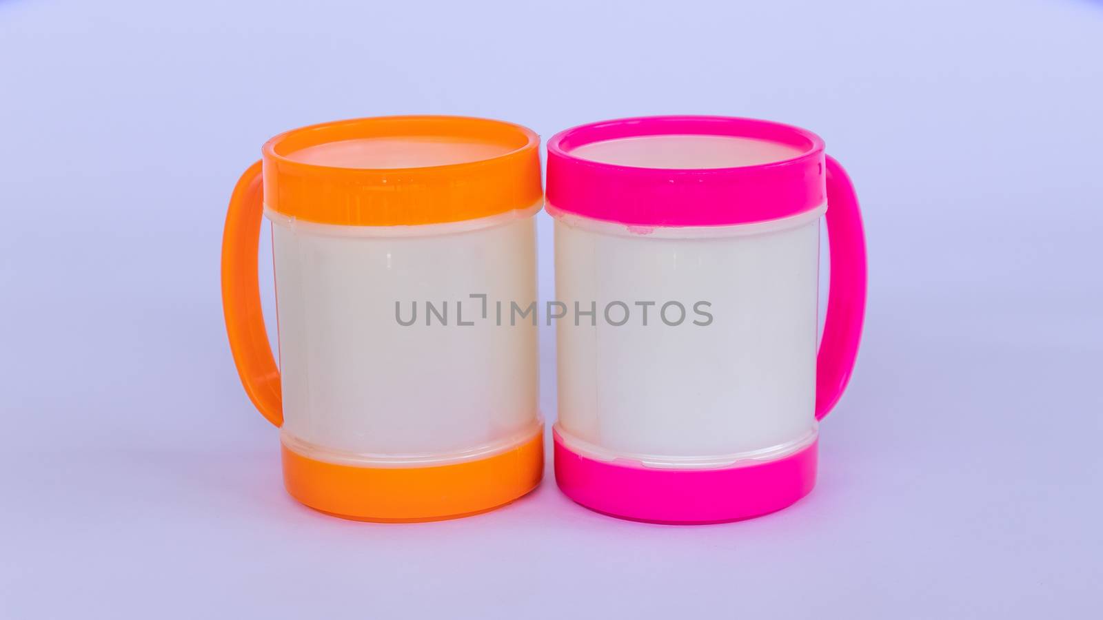 Two colorful plastic coffee mugs on a white background