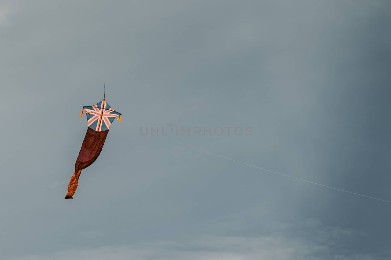 Kite fly against the dark moody sky, UK flag by nilanka
