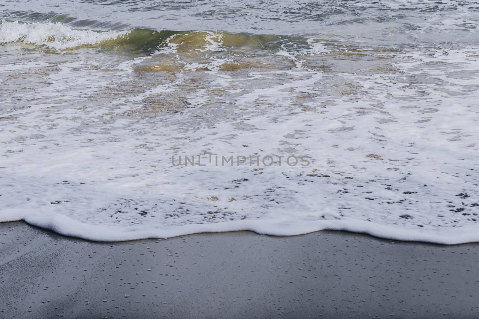 Calm sea waves wash over beautiful sand of the jungle beach by nilanka