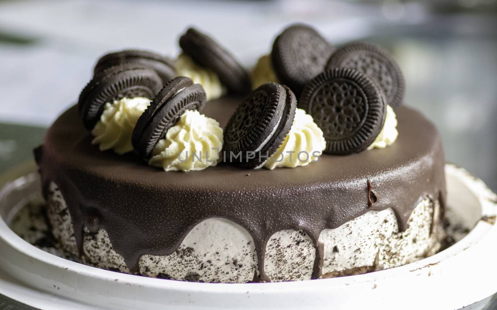 chocolate birthday cake with icing and dark chocolate biscuits on top