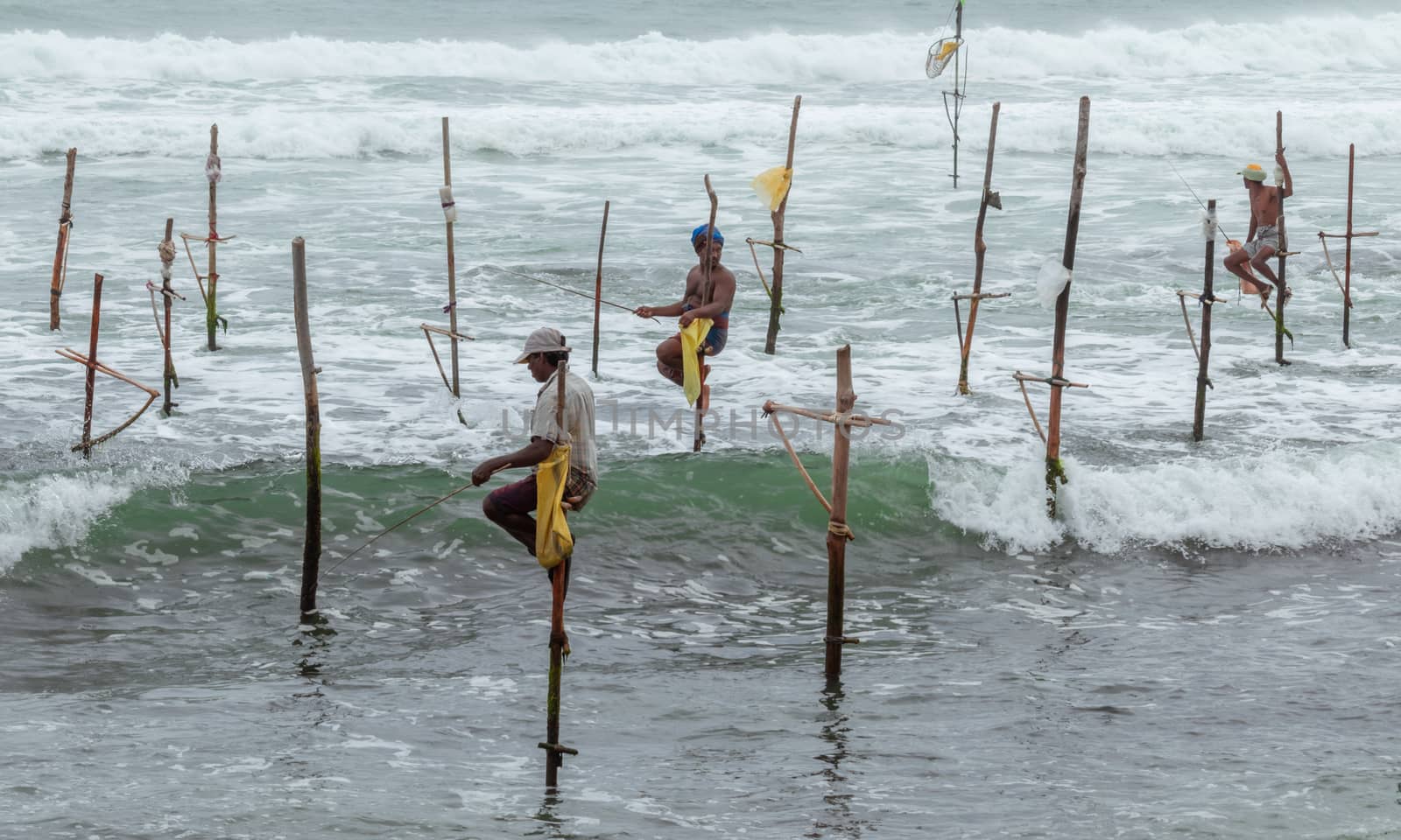 Weligama, Southern Province / Sri Lanka - 07 26 2020:Stilt fishermen beautiful scenery in southern Sri Lanka. by nilanka