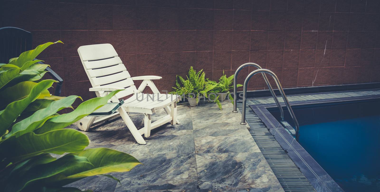 pool deck with white chair