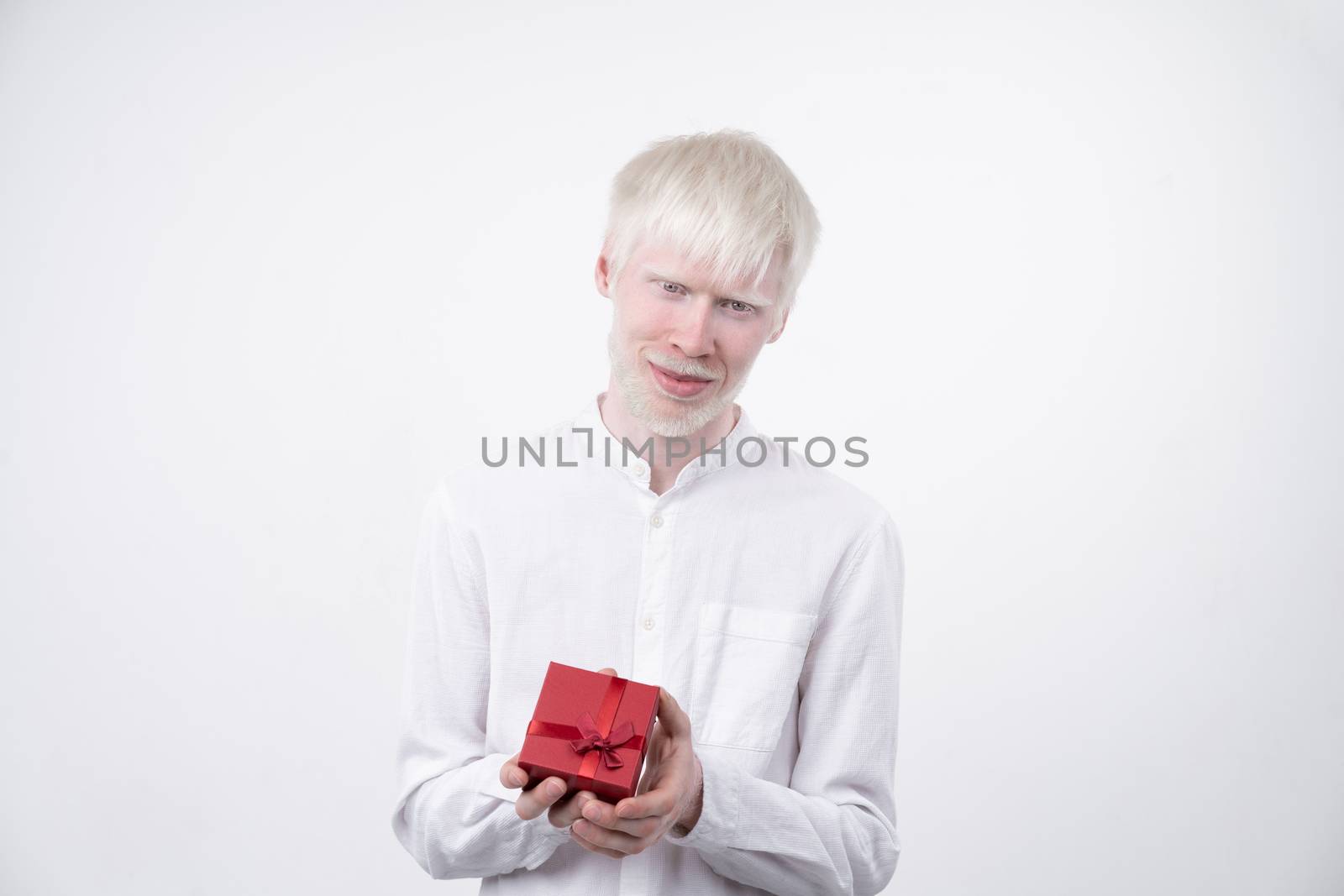 albinism albino man in studio dressed t-shirt isolated on a white background. abnormal deviations. unusual appearance. skin abnormality