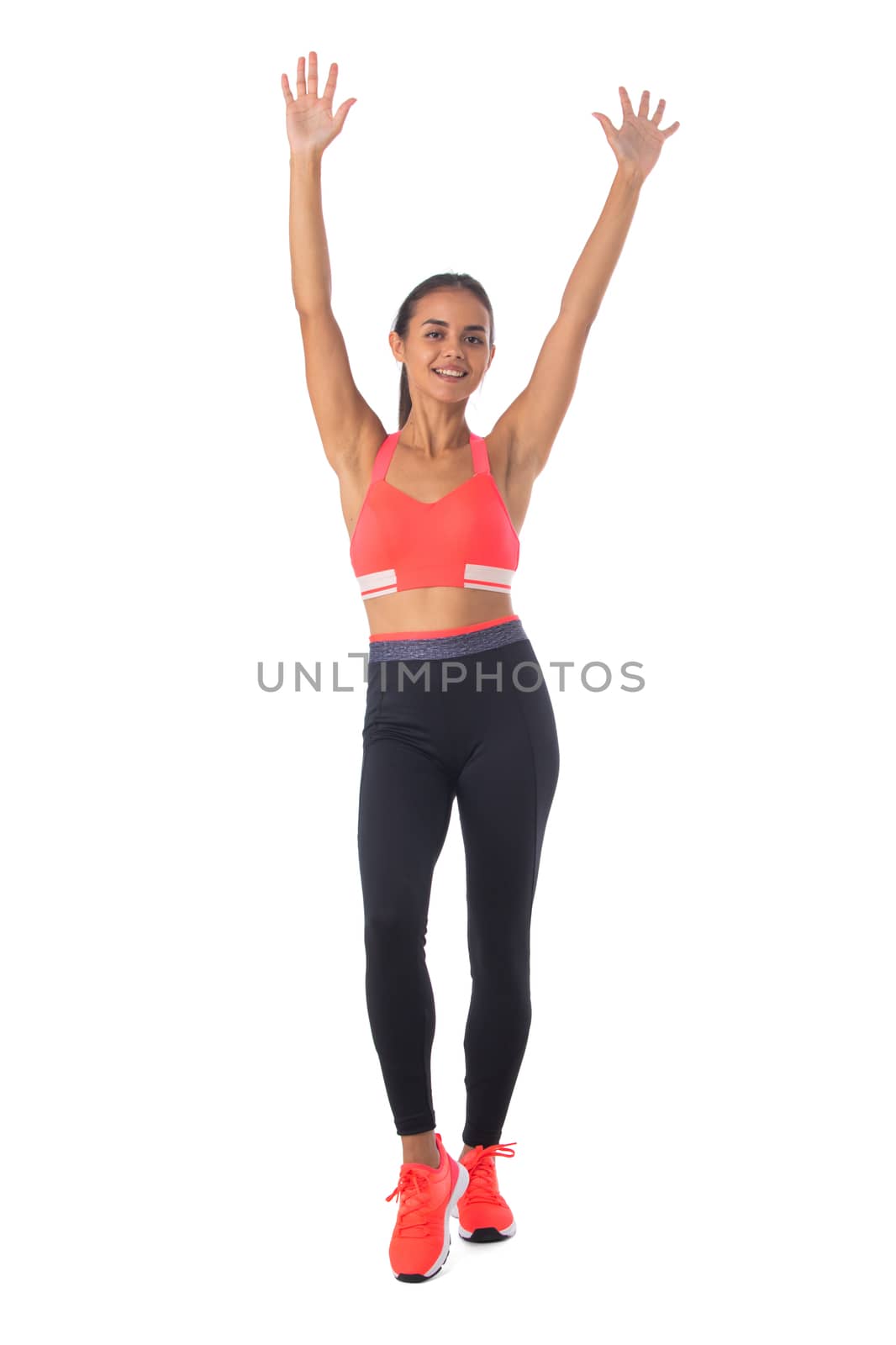 Healthy hispanic fitness girl with arms raised working out isolated on white background