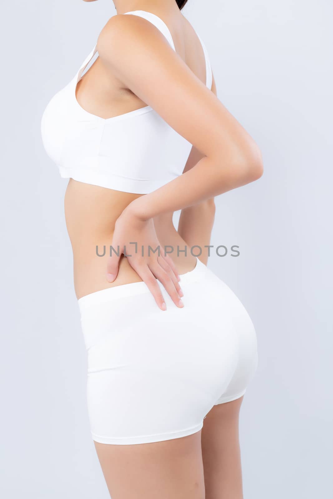 Closeup asian woman beautiful body diet with fit and hand touch bottom isolated on white background, model girl weight slim and butt with cellulite or calories, health and wellness concept.