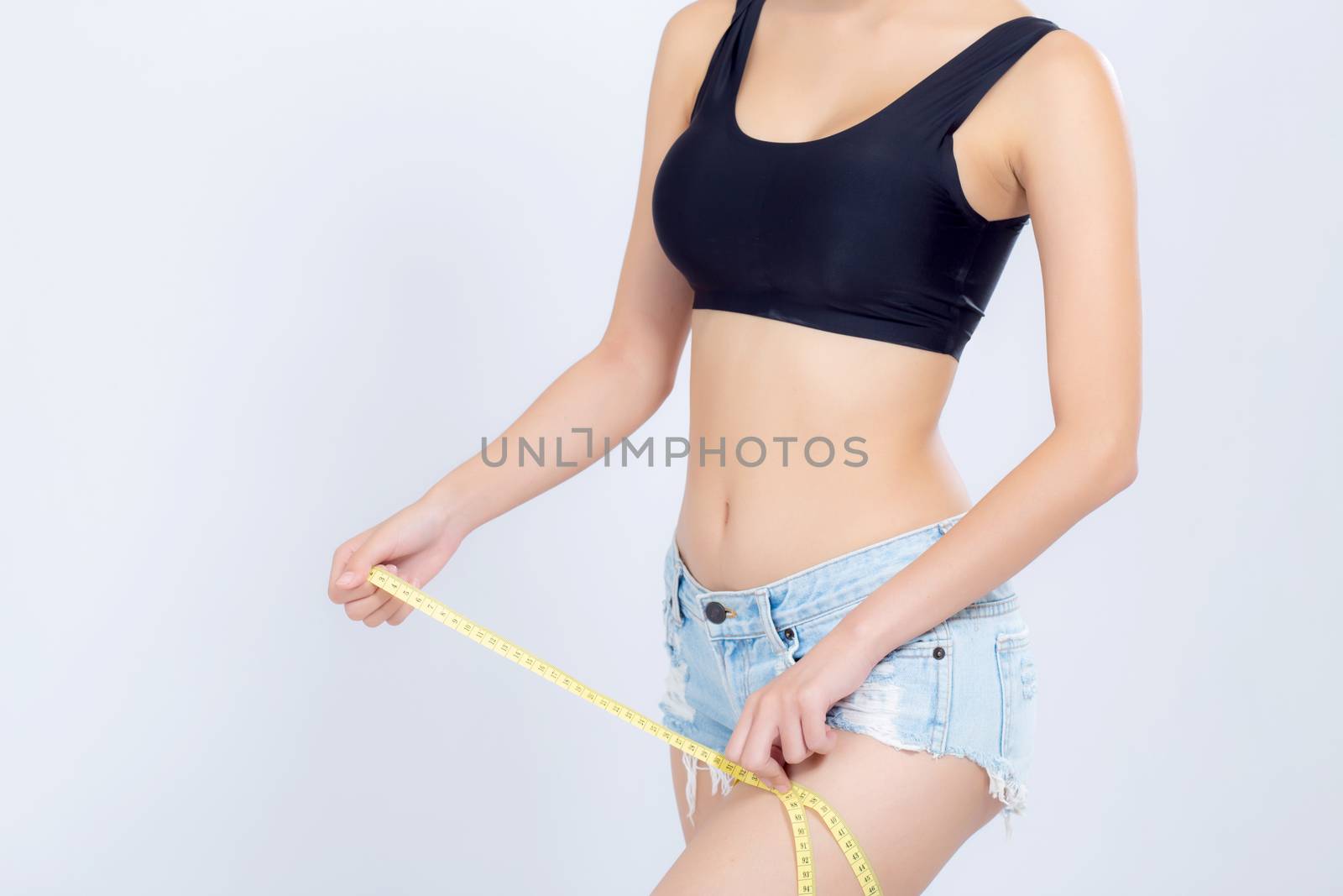 Closeup caucasian leg slim and body of woman with measure isolated on white background, girl with measuring centimeter  tape for healthy and diet, cellulite and calories for health care with perfect.
