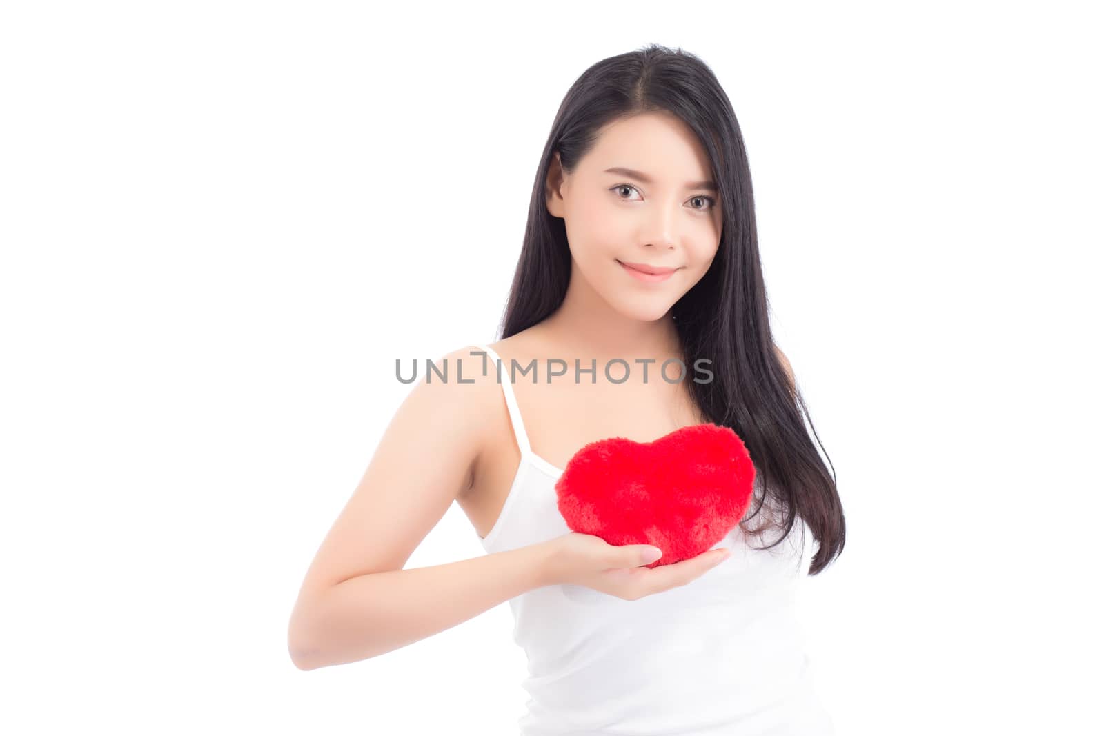 Portrait of beautiful asian young woman holding red heart shape pillow and smile isolated on white background, valentines day, holiday concept.