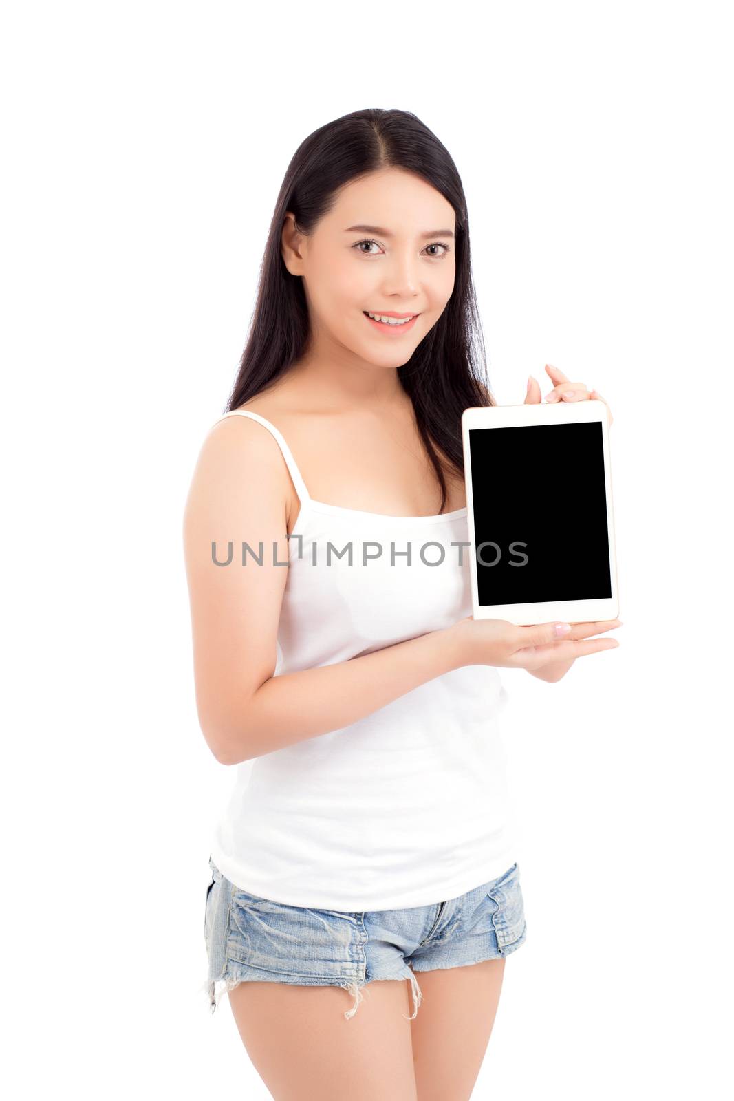 Portrait of asian young woman standing showing blank screen tablet isolated on white background, girl showing technology, business and communication concept.