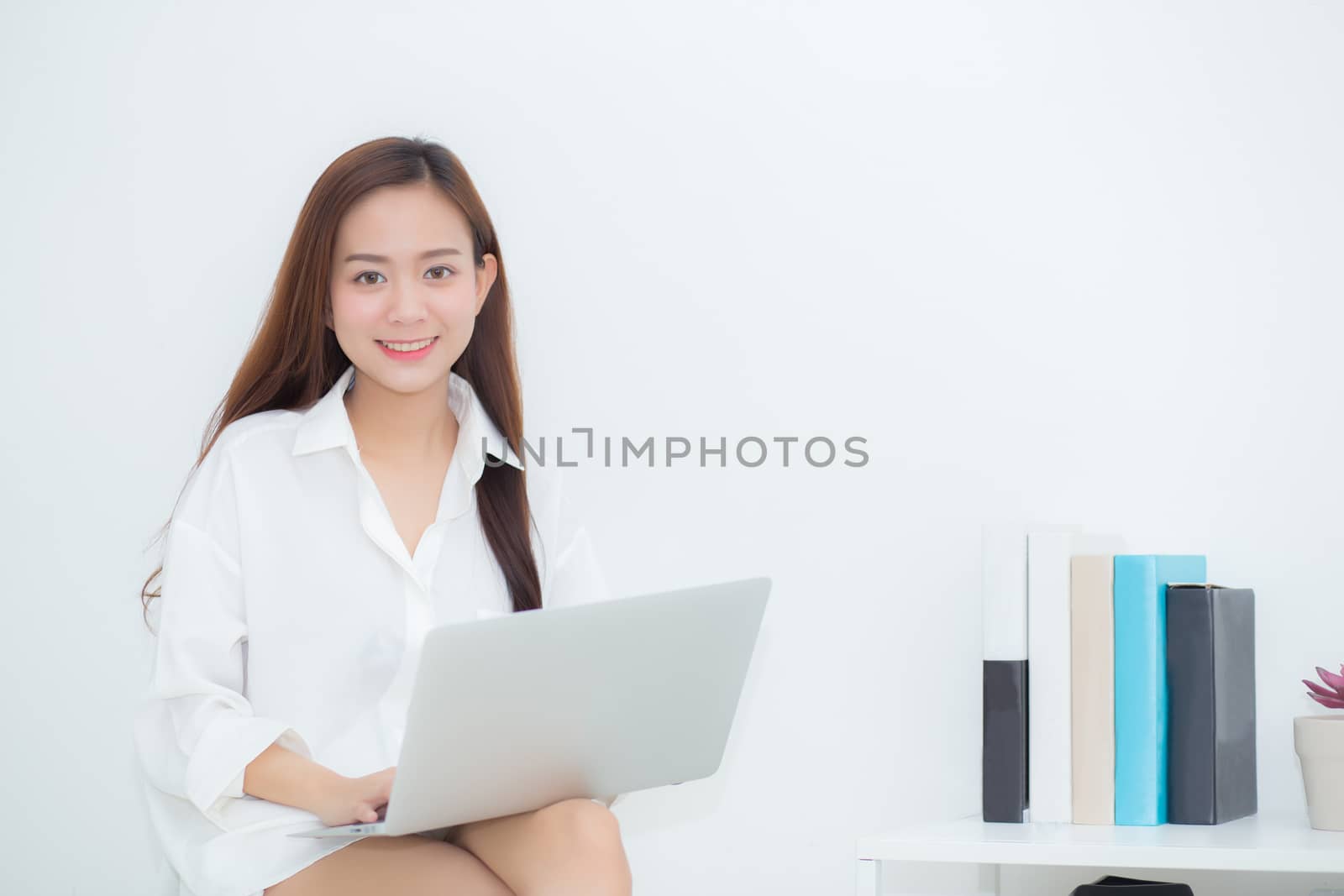 Beautiful young asian woman using laptop for leisure on sofa, girl working online with notebook freelance, communication business concept.