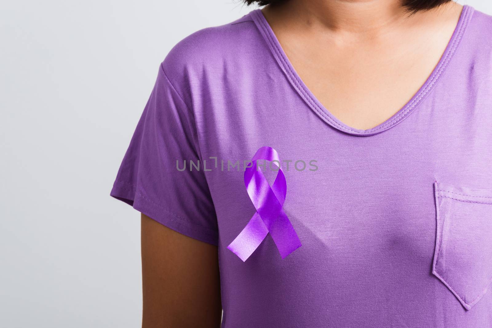 Young woman stick purple ribbon on the chest by Sorapop