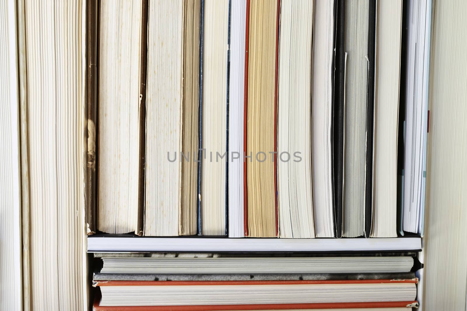 Row of used books  ,books with white paper , yellow pages and pages with signs of time