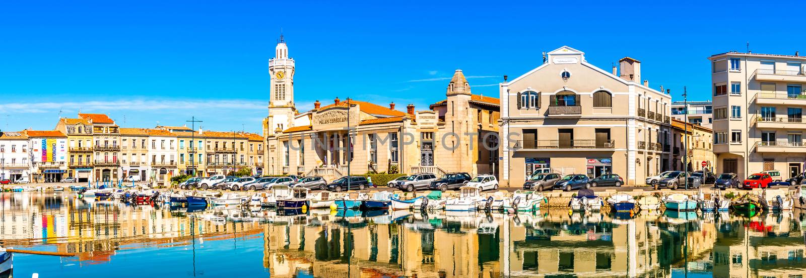 The facades and their reflections, along the Peyrade canal in Sète, in the Herault in Occitanie. by Frederic