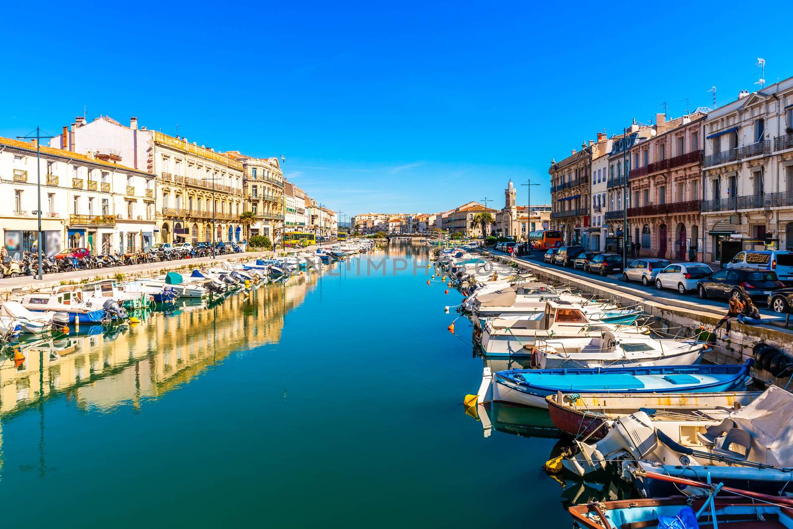 Almost perfect symmetry between the city and its reflection in the canal at Sète, in the department of Herault in Occitanie, in the south of France.