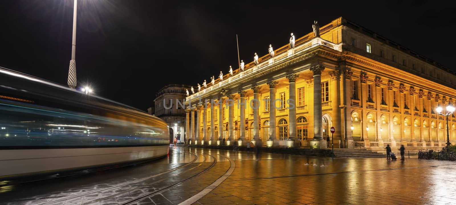 Tram passing the Grand Théâtre de Bordeaux at night in New Aquitaine, France. by Frederic