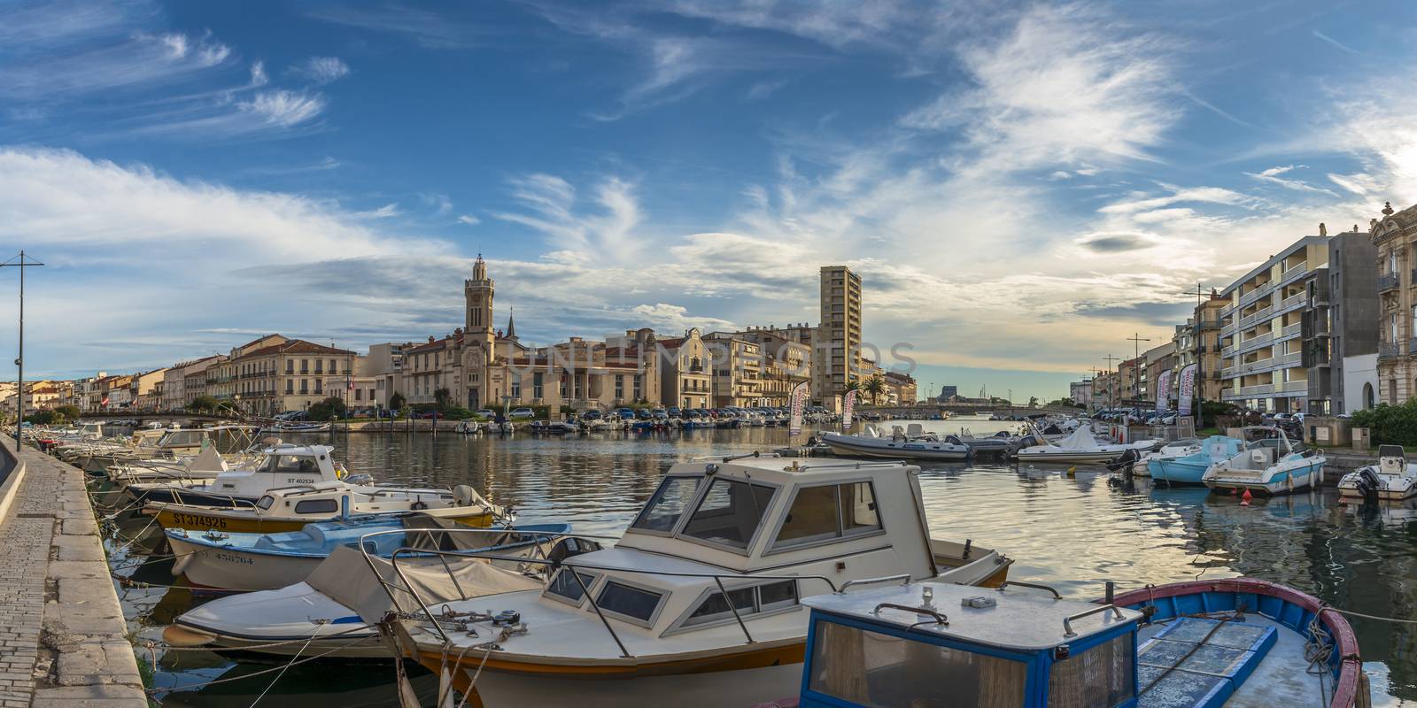 Panoramic view at the crossroads of the Royal Canal and the Peyrade Canal and of the Consular Palace in Sete in the Herault, on a summer morning, in Occitanie