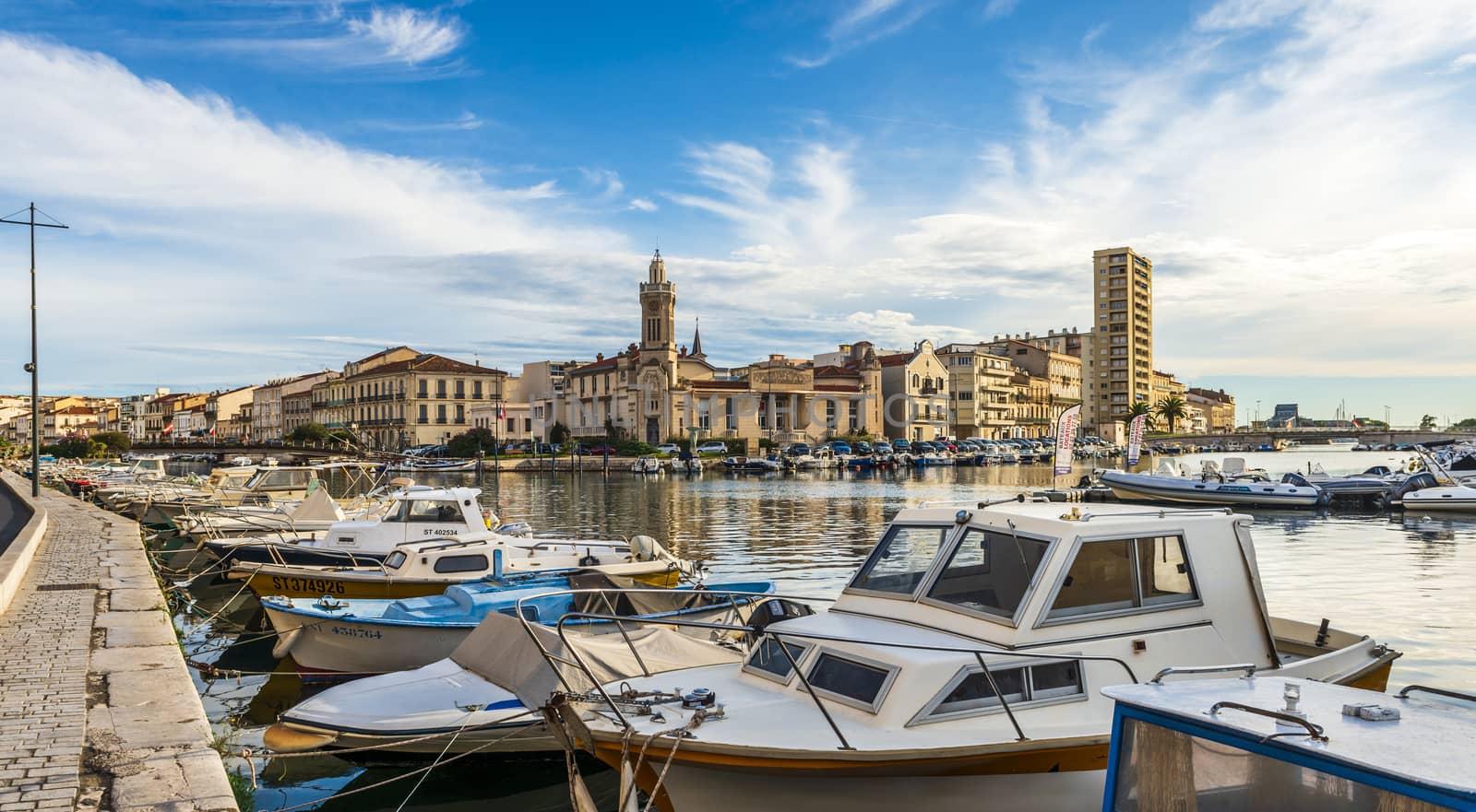 Panoramic view at the crossroads of the Royal Canal and the Peyrade Canal and of the Consular Palace in Sete in the Herault, on a summer morning, in Occitanie