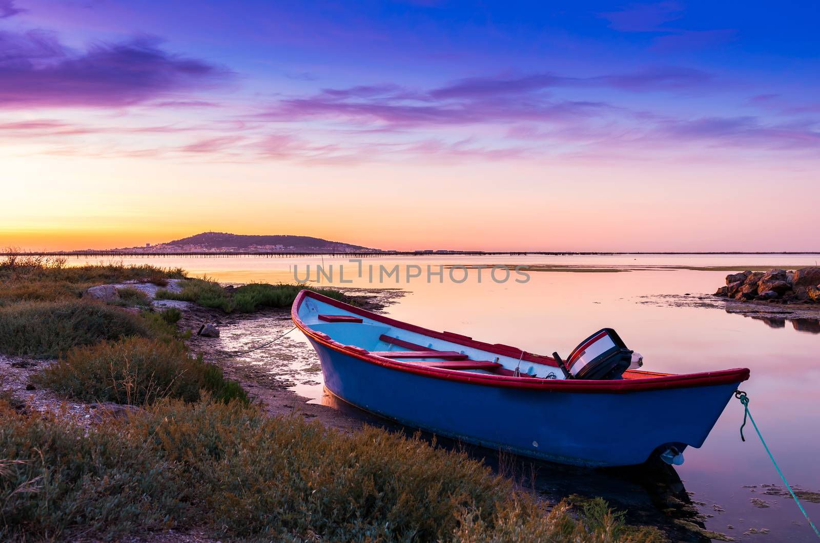 Rowboat on the Etang de Thau à Meze at dusk, in Hérault in Occitanie, France. by Frederic