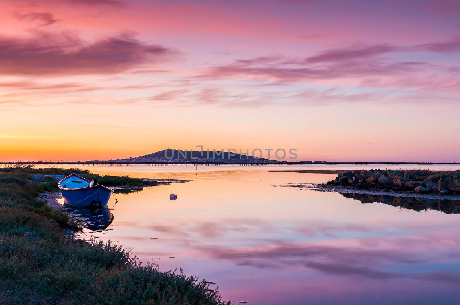 Landscape of the Etang de Thau just before sunrise and Mont Saint-Clair in the background, in the Occitanie region, in the south of France.